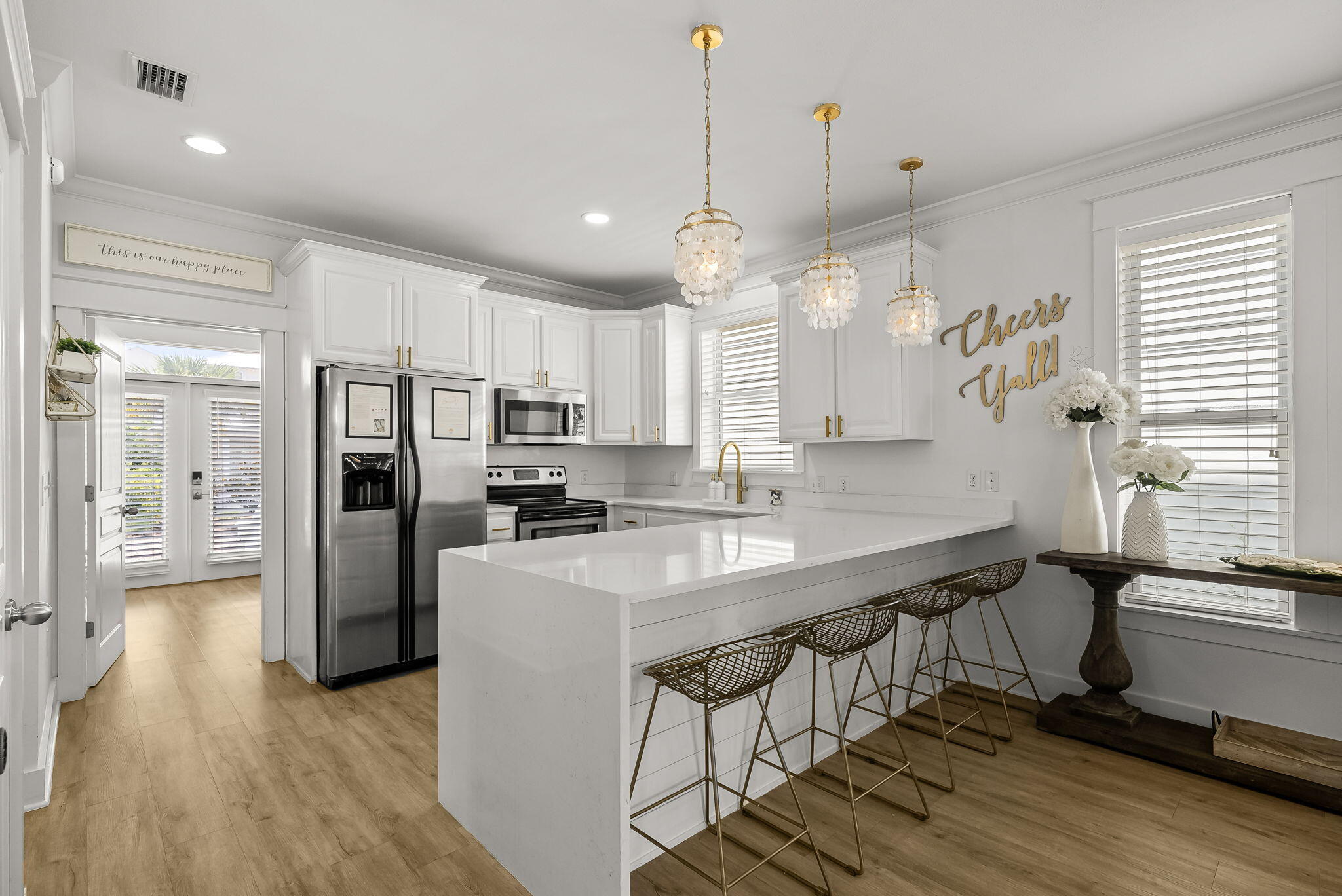 22 Moonlight Beach Lane Inlet Beach, FL 32461 - Photo 18 of 70 a kitchen with kitchen island a stove a refrigerator a sink and dishwasher with wooden floor