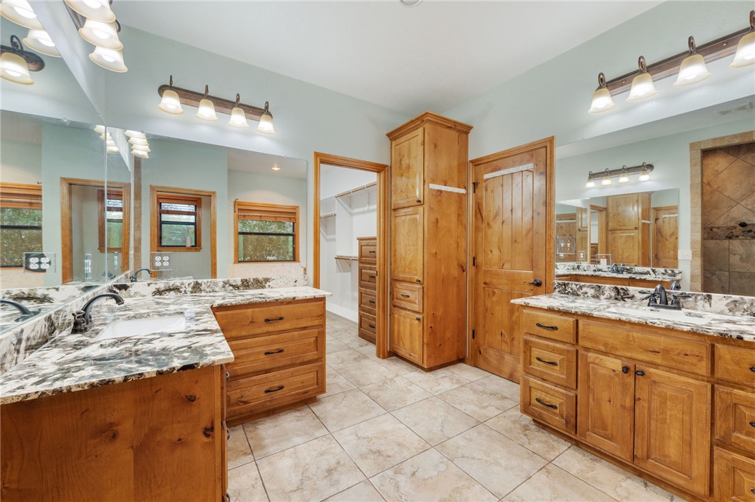 7754 Edge Cut Off Road Hearne, TX 77859 - Photo 16 of 49 Bathroom with two vanities and a walk in closet