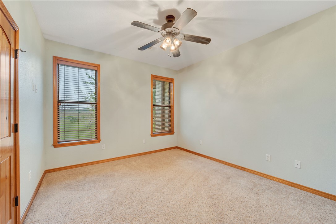 7754 Edge Cut Off Road Hearne, TX 77859 - Photo 20 of 49 Unfurnished room featuring light carpet and ceiling fan