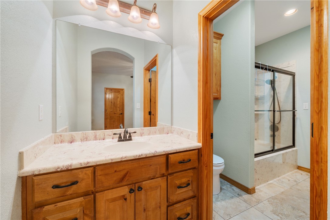 7754 Edge Cut Off Road Hearne, TX 77859 - Photo 24 of 49 a bathroom with a granite countertop sink and a mirror