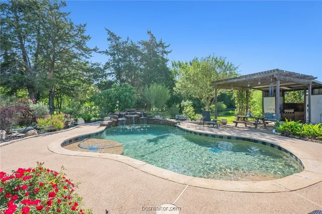 an aerial view of a house with a yard basket ball court and outdoor seating