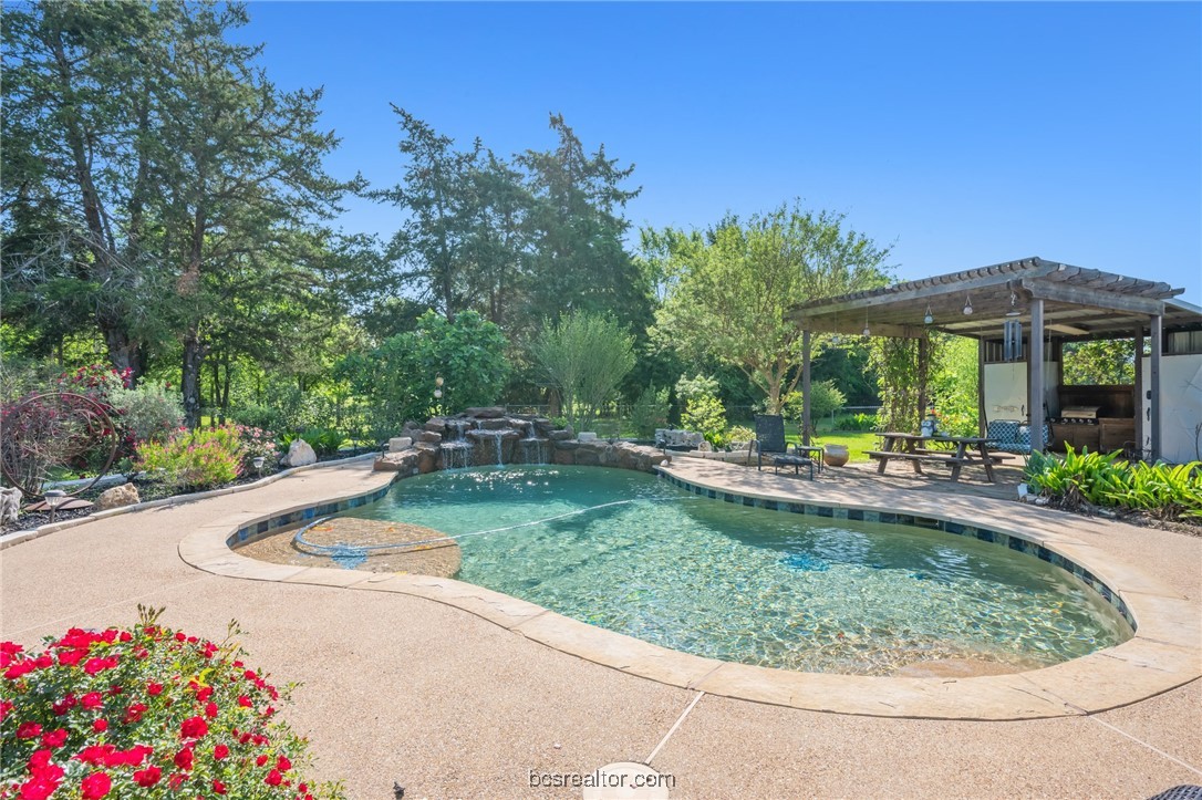 7754 Edge Cut Off Road Hearne, TX 77859 - Photo 33 of 49 a view of a swimming pool with a garden