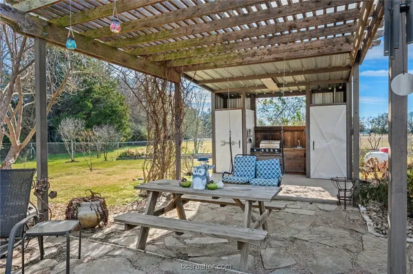 a view of a swimming pool with a patio and a yard
