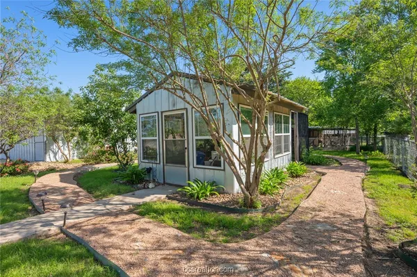 an aerial view of a house with a yard basket ball court and outdoor seating