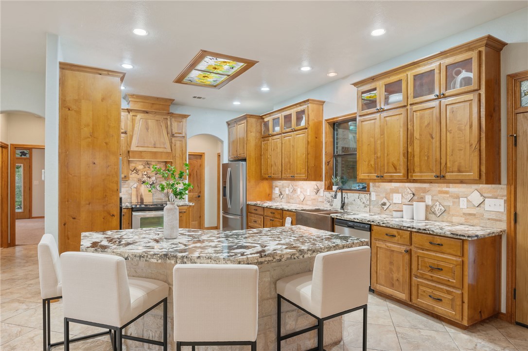 7754 Edge Cut Off Road Hearne, TX 77859 - Photo 7 of 49 a kitchen with a stove a sink and a refrigerator