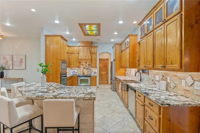 a bathroom with a granite countertop tub sink and mirror