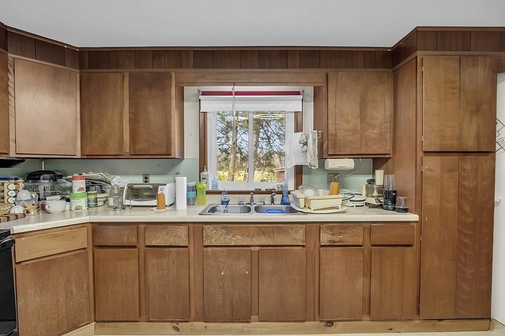 320 Bolton Road Lancaster, MA 01523 - Photo 11 of 28 a kitchen with a sink a window and cabinets
