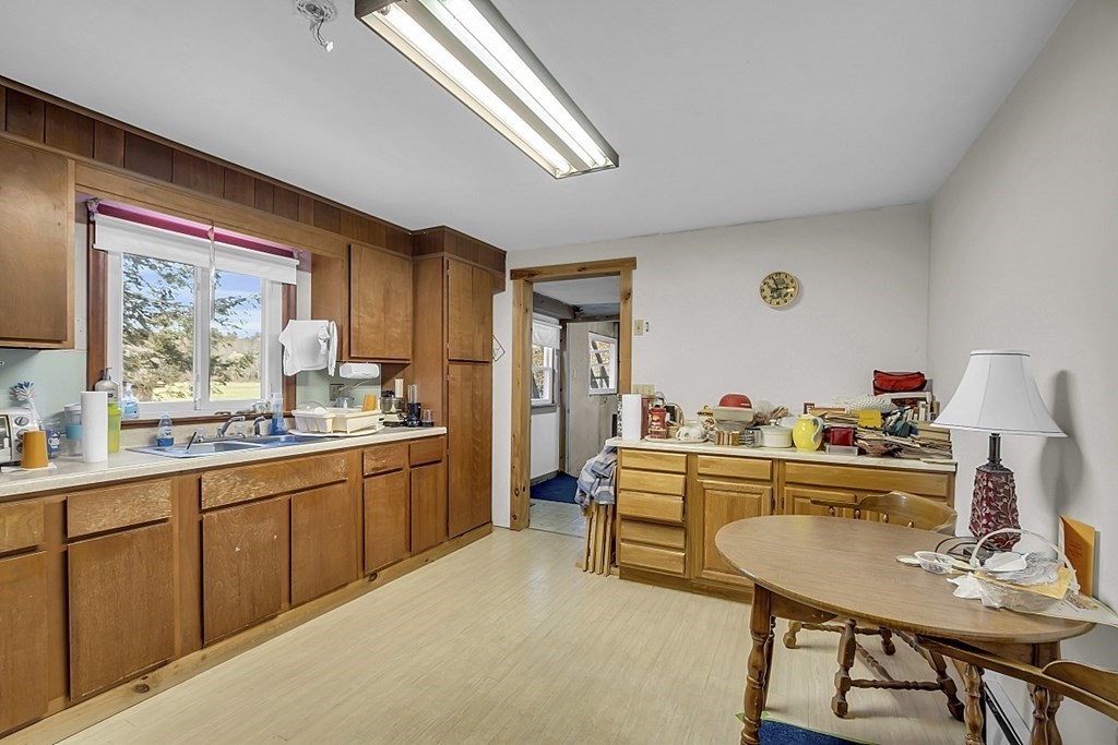 320 Bolton Road Lancaster, MA 01523 - Photo 12 of 28 a kitchen with sink cabinets and window