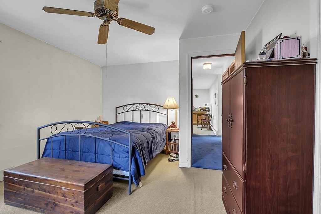 320 Bolton Road Lancaster, MA 01523 - Photo 14 of 28 a bedroom with a bed and a mirror