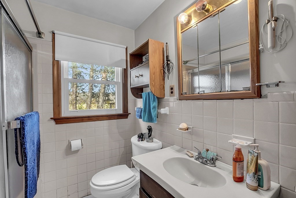 320 Bolton Road Lancaster, MA 01523 - Photo 16 of 28 a bathroom with a toilet sink and mirror