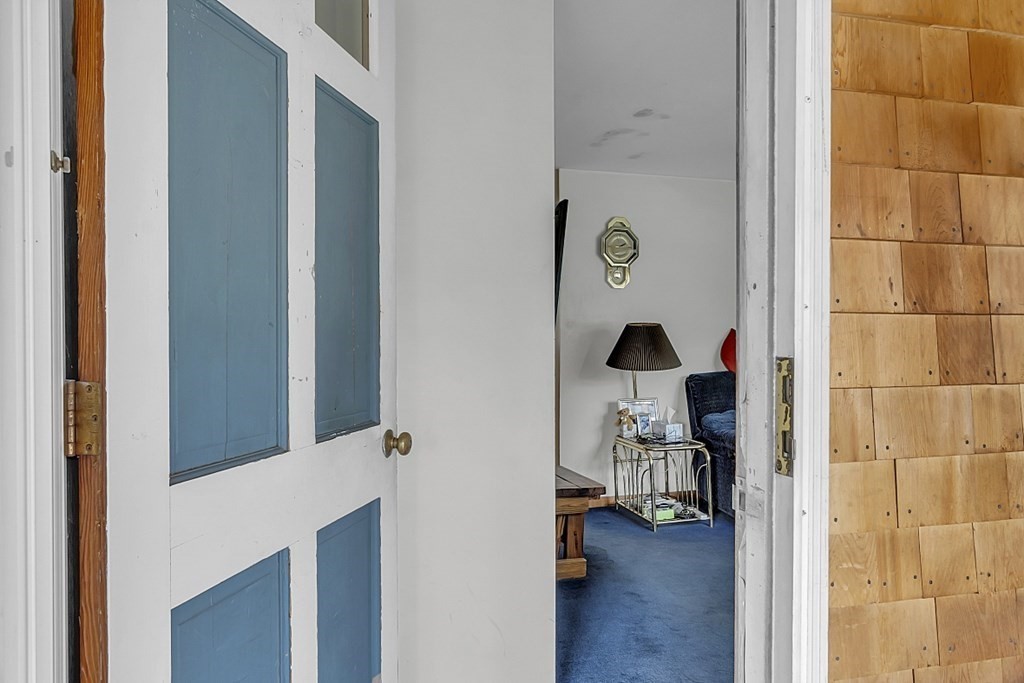 320 Bolton Road Lancaster, MA 01523 - Photo 17 of 28 a view of hallway with chair and wooden floor
