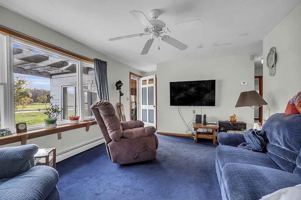 320 Bolton Road Lancaster, MA 01523 - Photo 18 of 28 a living room with furniture a flat screen tv and a large window