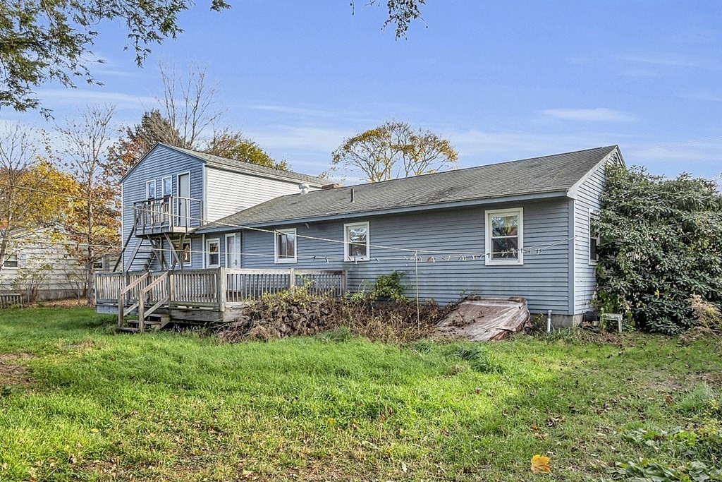 320 Bolton Road Lancaster, MA 01523 - Photo 2 of 28 a brick house with a small yard and plants