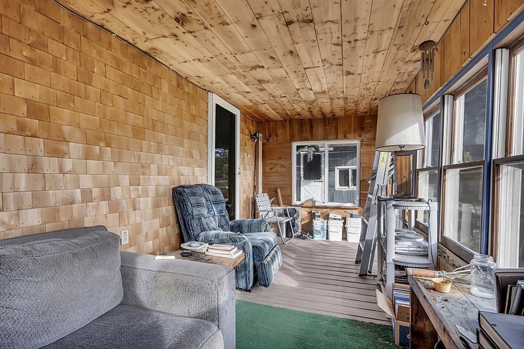 320 Bolton Road Lancaster, MA 01523 - Photo 22 of 28 a view of a patio with couches chairs potted plants and wooden floor
