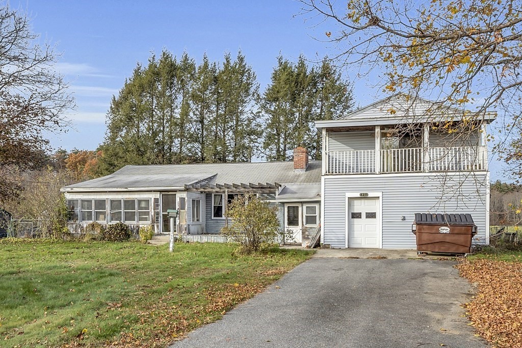 320 Bolton Road Lancaster, MA 01523 - Photo 3 of 28 a front view of a house with a garden