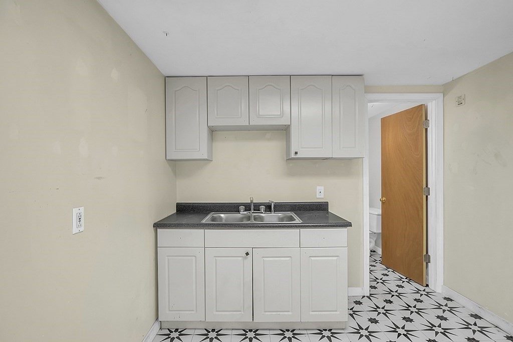 320 Bolton Road Lancaster, MA 01523 - Photo 5 of 28 a kitchen with stainless steel appliances granite countertop a sink stove and cabinets