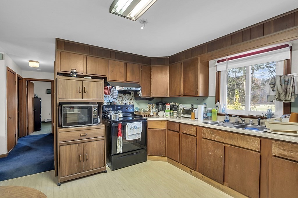 320 Bolton Road Lancaster, MA 01523 - Photo 9 of 28 a kitchen with stainless steel appliances granite countertop a refrigerator sink and stove