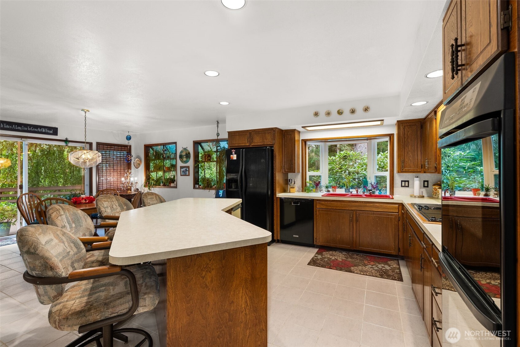 43 Hines Valley Road Raymond, WA 98577 - Photo 16 of 40 a kitchen with stainless steel appliances kitchen island granite countertop a refrigerator a stove top oven a sink with island and chairs
