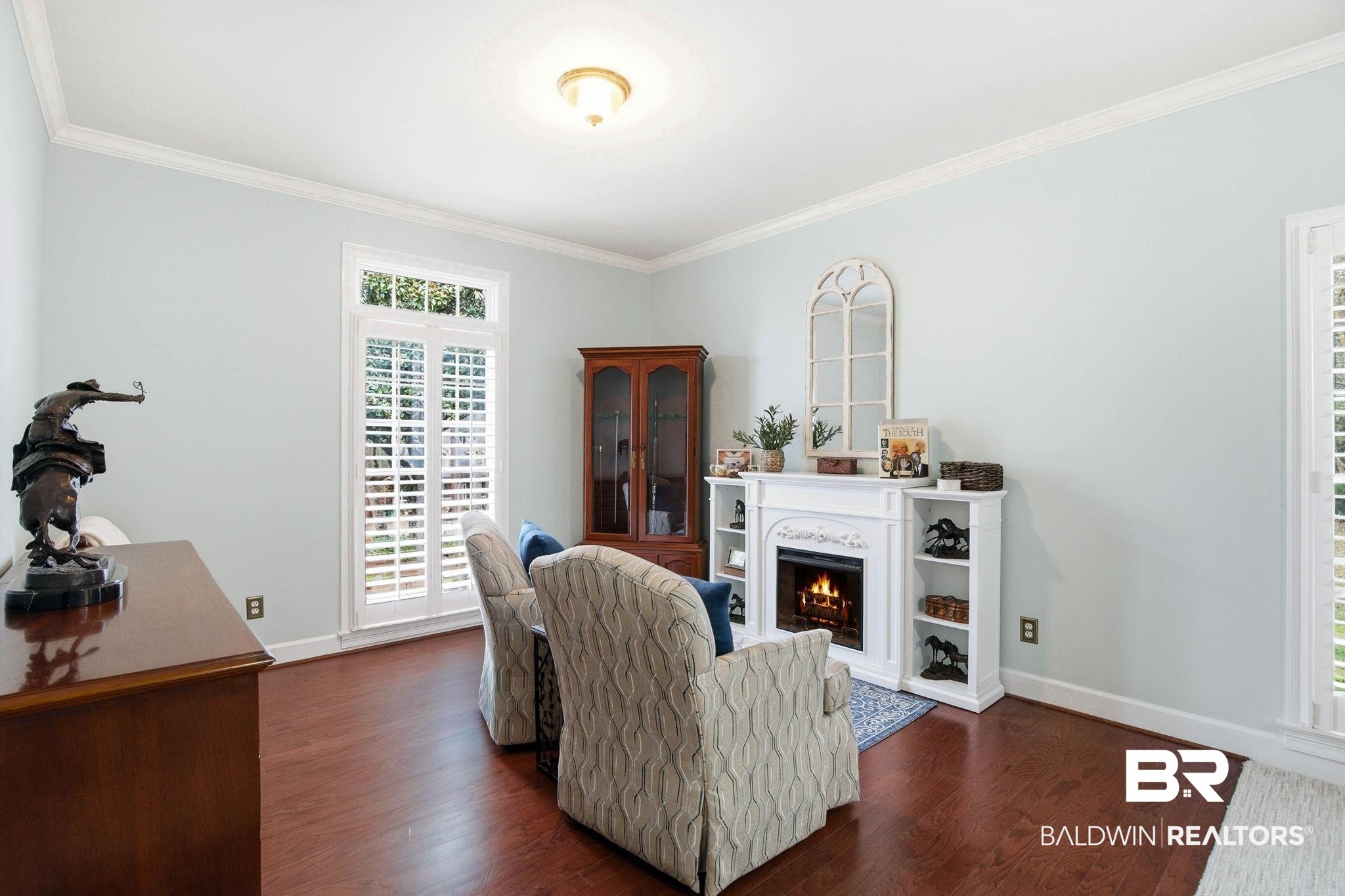 31515 Rhett Drive Spanish Fort, AL 36527 - Photo 32 of 100 The oversize primary suite has TWO walk in closets, a coat closet, a sitting area with an electric fireplace, crown molding, a large linen closet, and plantation shutters. The primary suite measures 16' 2" x 34' 6"