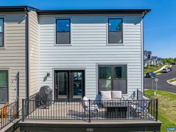 a view of a house with a balcony and wooden floor