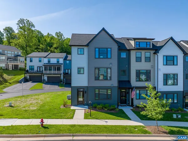 a front view of a residential apartment building with a yard