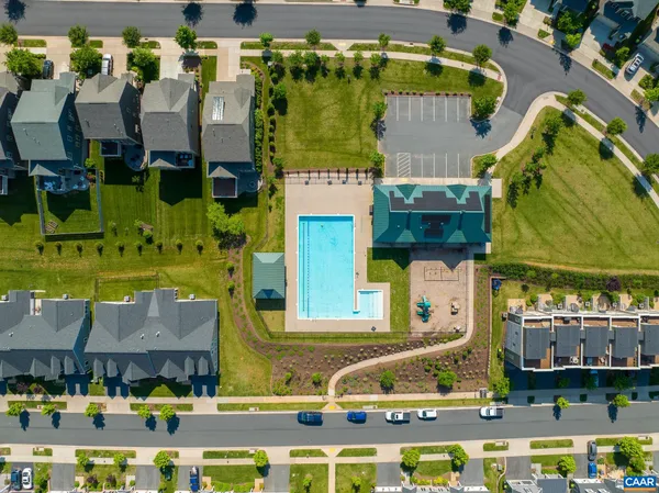 an aerial view of residential houses with outdoor space and swimming pool