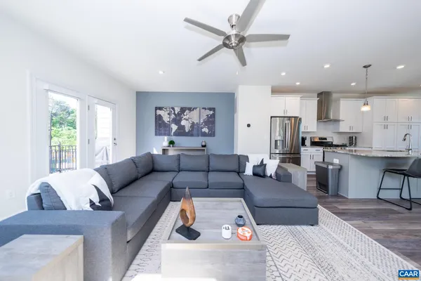 a living room with furniture kitchen and a window