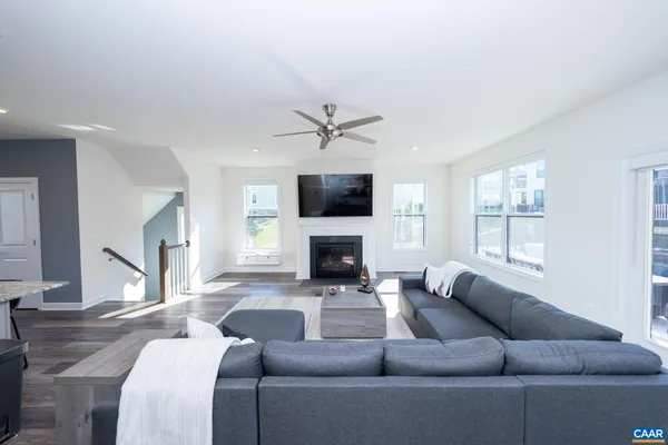 a living room with a couch a fireplace and a large window