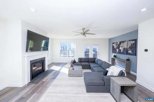 a living room with furniture a fireplace and a flat screen tv