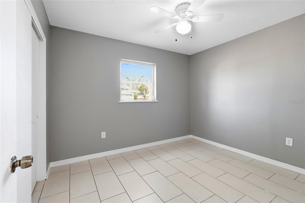 363 Glen Oak Road Venice, FL 34293 - Photo 40 of 53 an empty room with a chandelier fan and windows