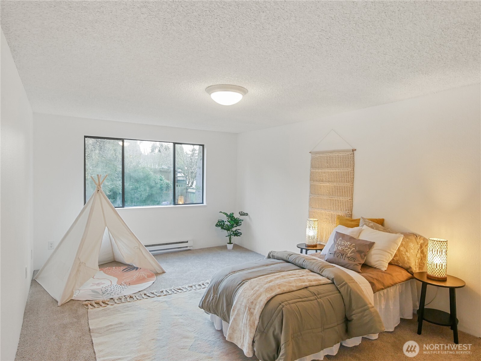 30853 13th Place South, Unit 2 Federal Way, WA 98003 - Photo 22 of 37 a bed sitting in a bedroom next to a window