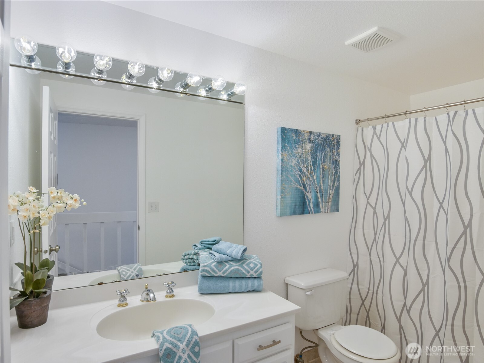 30853 13th Place South, Unit 2 Federal Way, WA 98003 - Photo 24 of 37 a bathroom with a sink a toilet and shower curtain