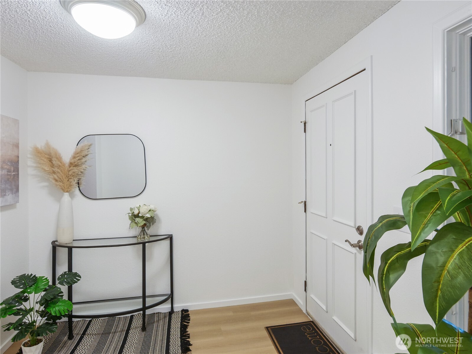 30853 13th Place South, Unit 2 Federal Way, WA 98003 - Photo 3 of 37 a view of a hallway with paintings on the wall