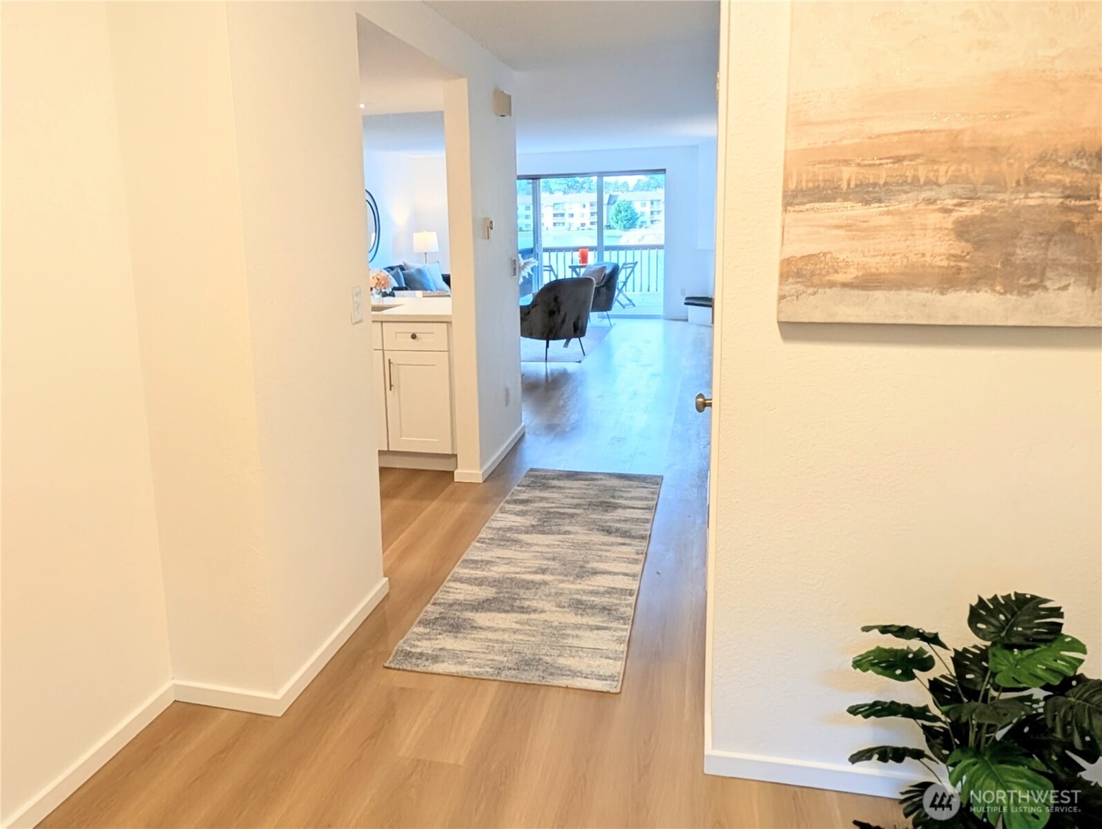 30853 13th Place South, Unit 2 Federal Way, WA 98003 - Photo 4 of 37 a view of a hallway with wooden floor and a living room
