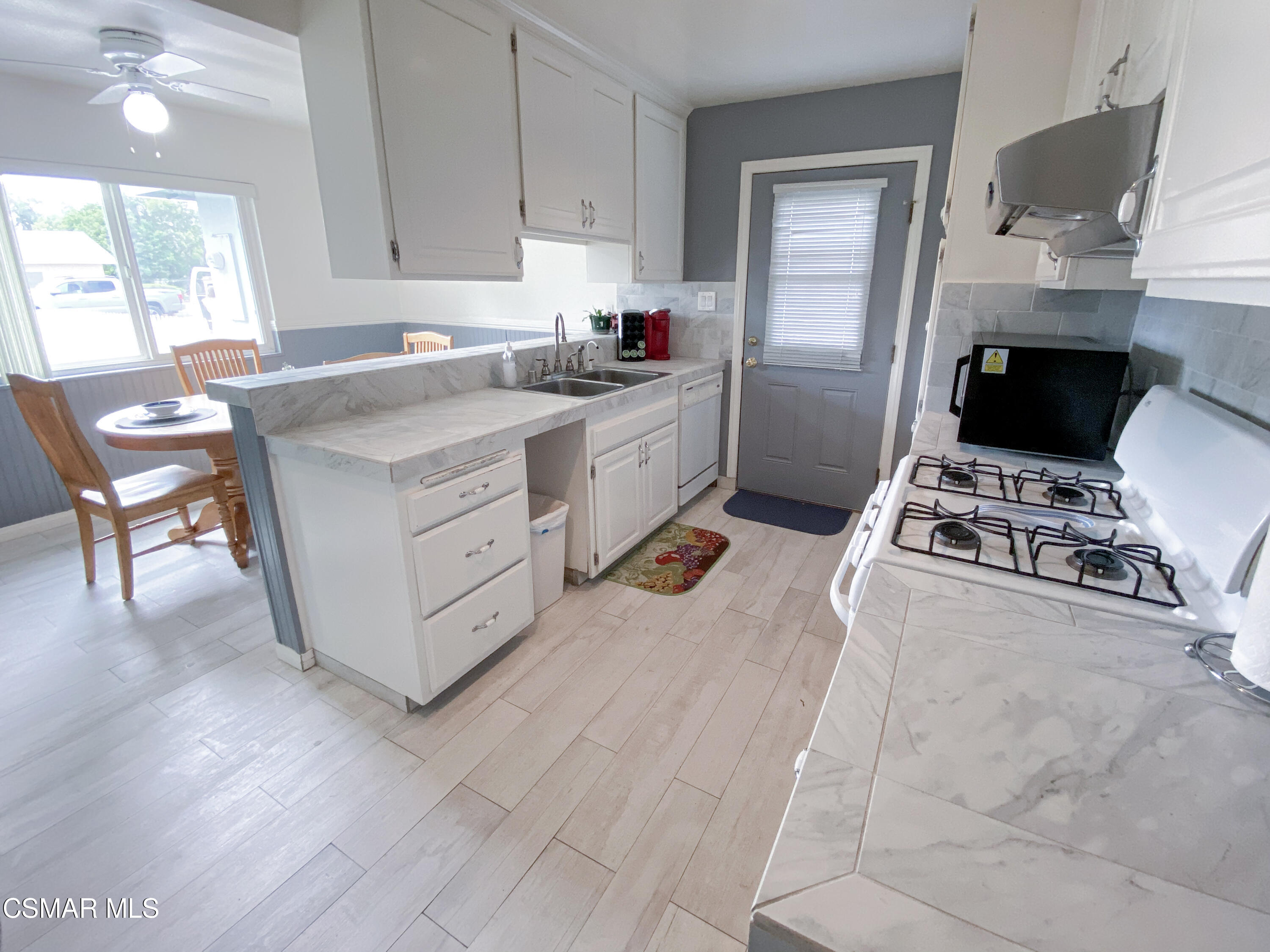 4245 Adam Road Simi Valley, CA 93063 - Photo 3 of 20 a kitchen with a stove a sink and a refrigerator