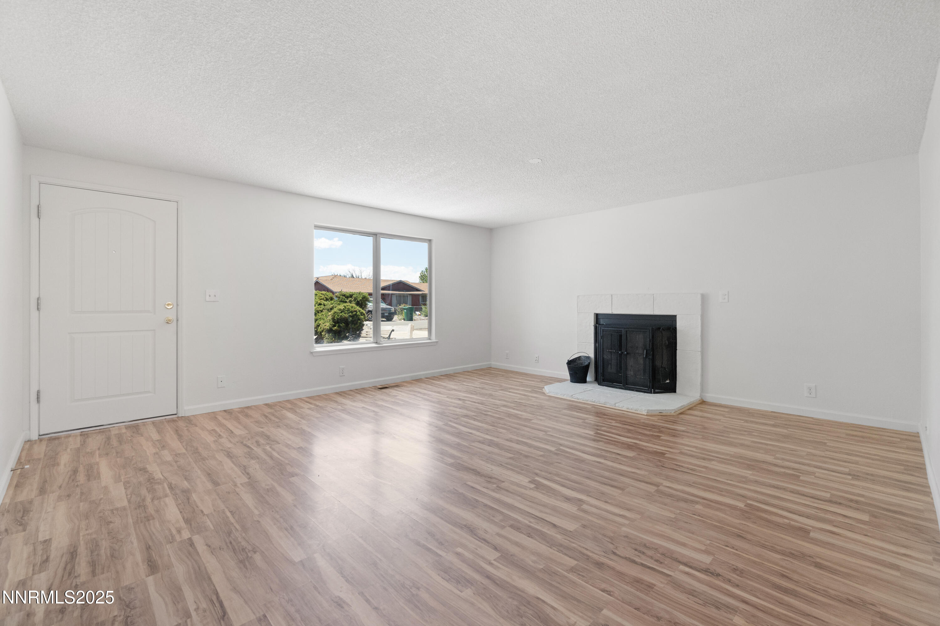 129 Ring Road Dayton, NV 89403 - Photo 8 of 27 a view of an empty room with wooden floor and a window