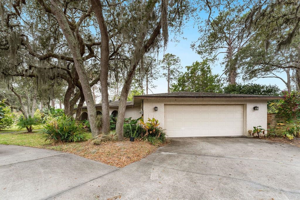 708 Prince Road St. Augustine, FL 32086 - Photo 2 of 41 a view of a house with a yard and garage