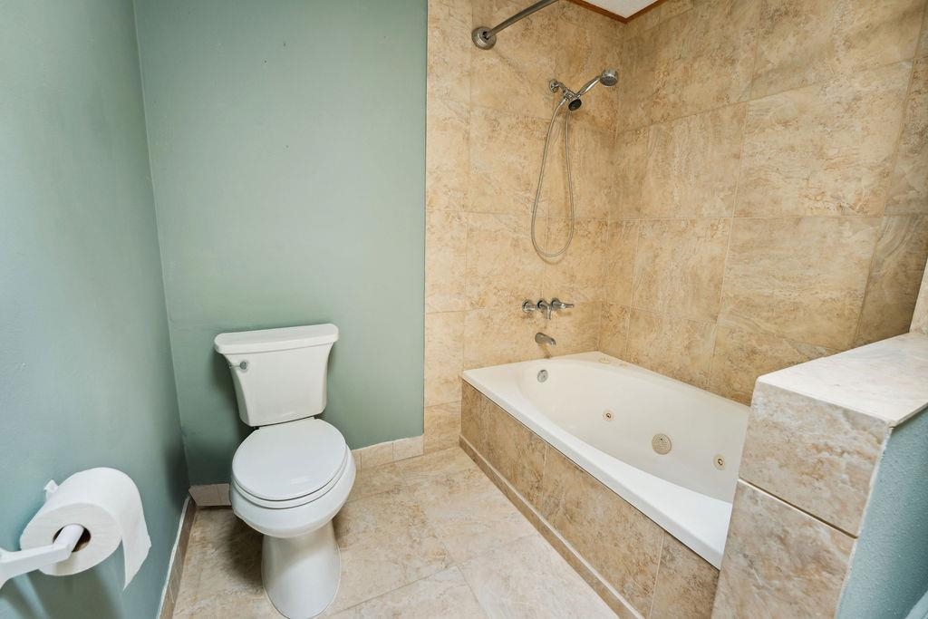708 Prince Road St. Augustine, FL 32086 - Photo 23 of 41 a white toilet sitting next to a bath tub and a shower