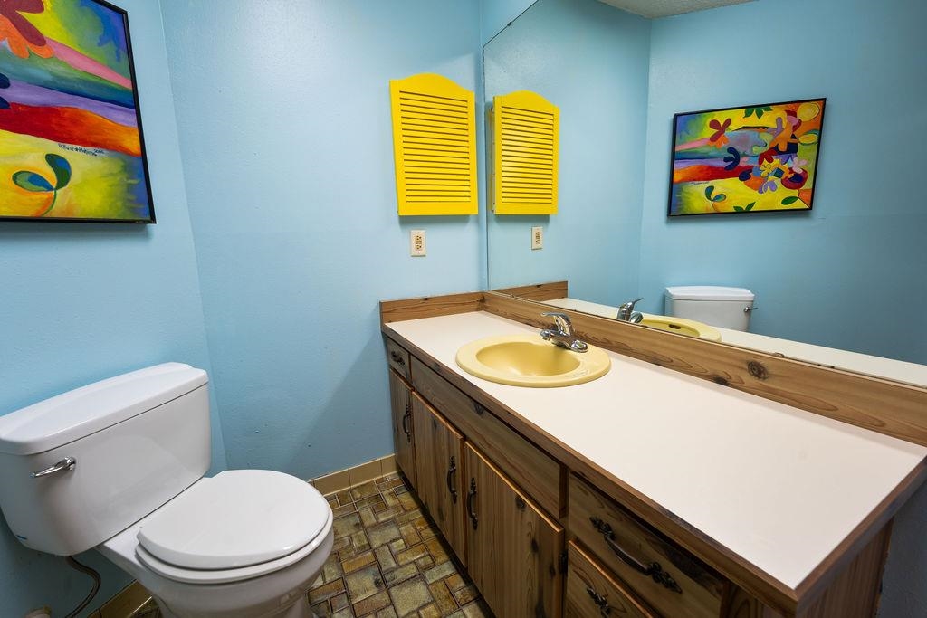 708 Prince Road St. Augustine, FL 32086 - Photo 31 of 41 a bathroom with a sink a toilet and painting on the wall