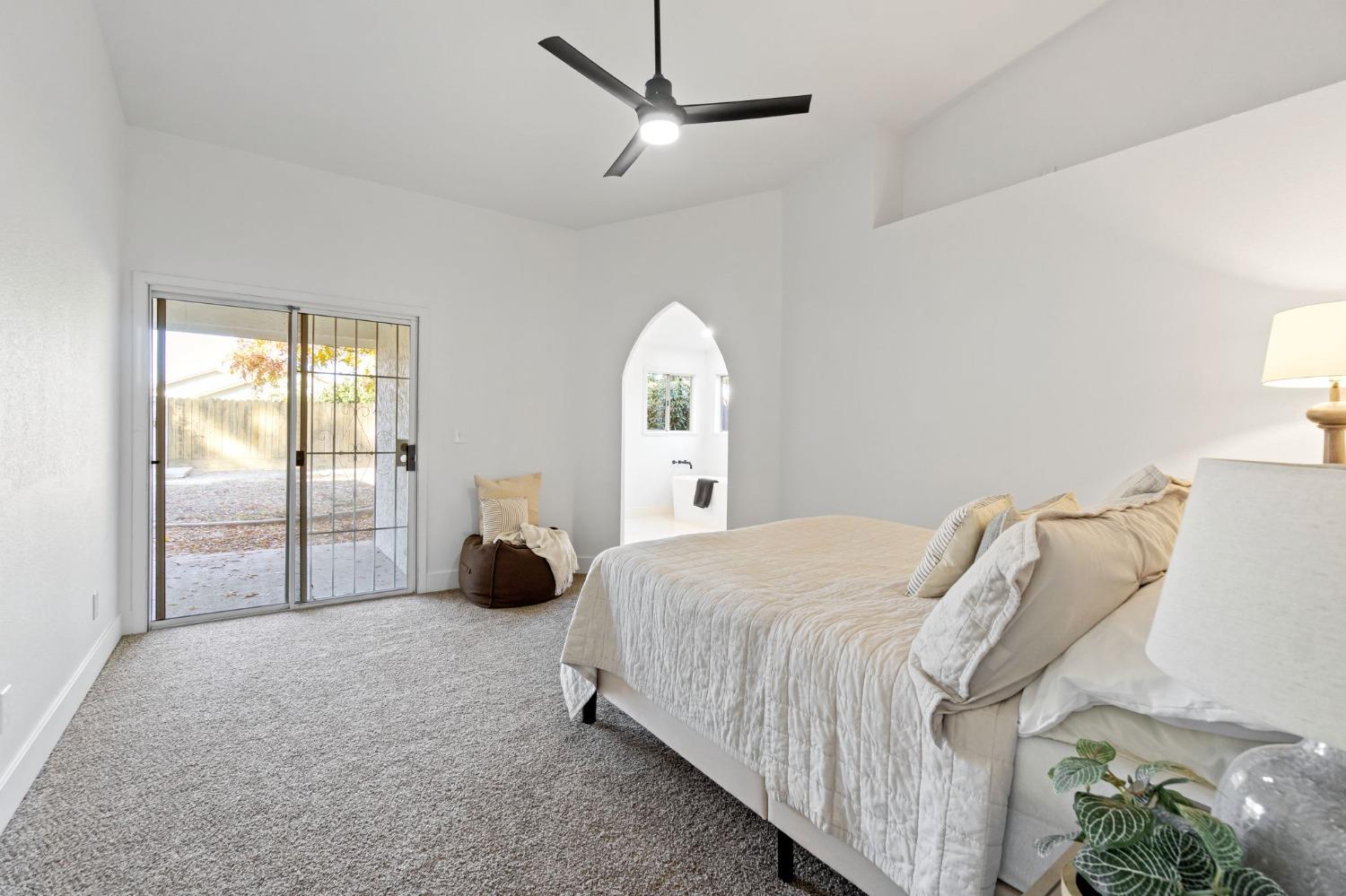 2481 Gibson Avenue Clovis, CA 93611 - Photo 14 of 24 a bedroom with a bed and a large window