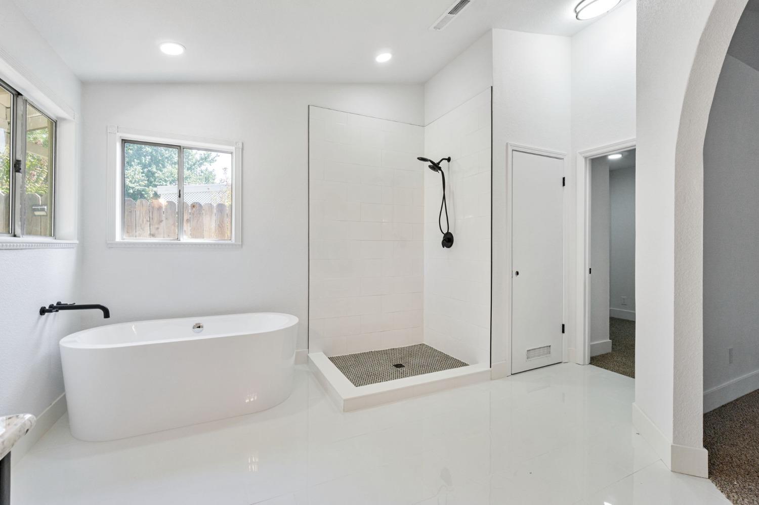 2481 Gibson Avenue Clovis, CA 93611 - Photo 16 of 24 a bathroom with a bathtub and shower