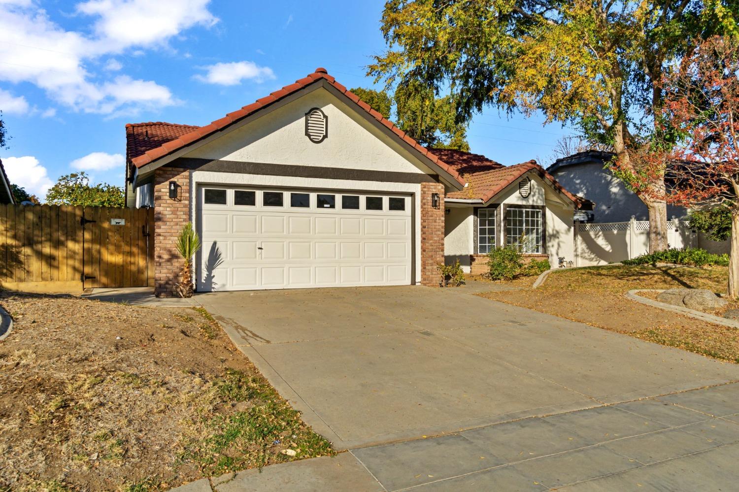 2481 Gibson Avenue Clovis, CA 93611 - Photo 2 of 24 a front view of a house with a yard