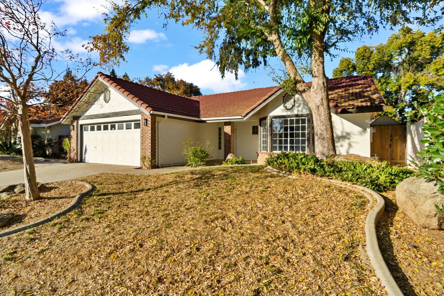 2481 Gibson Avenue Clovis, CA 93611 - Photo 3 of 24 a front view of a house with a garden