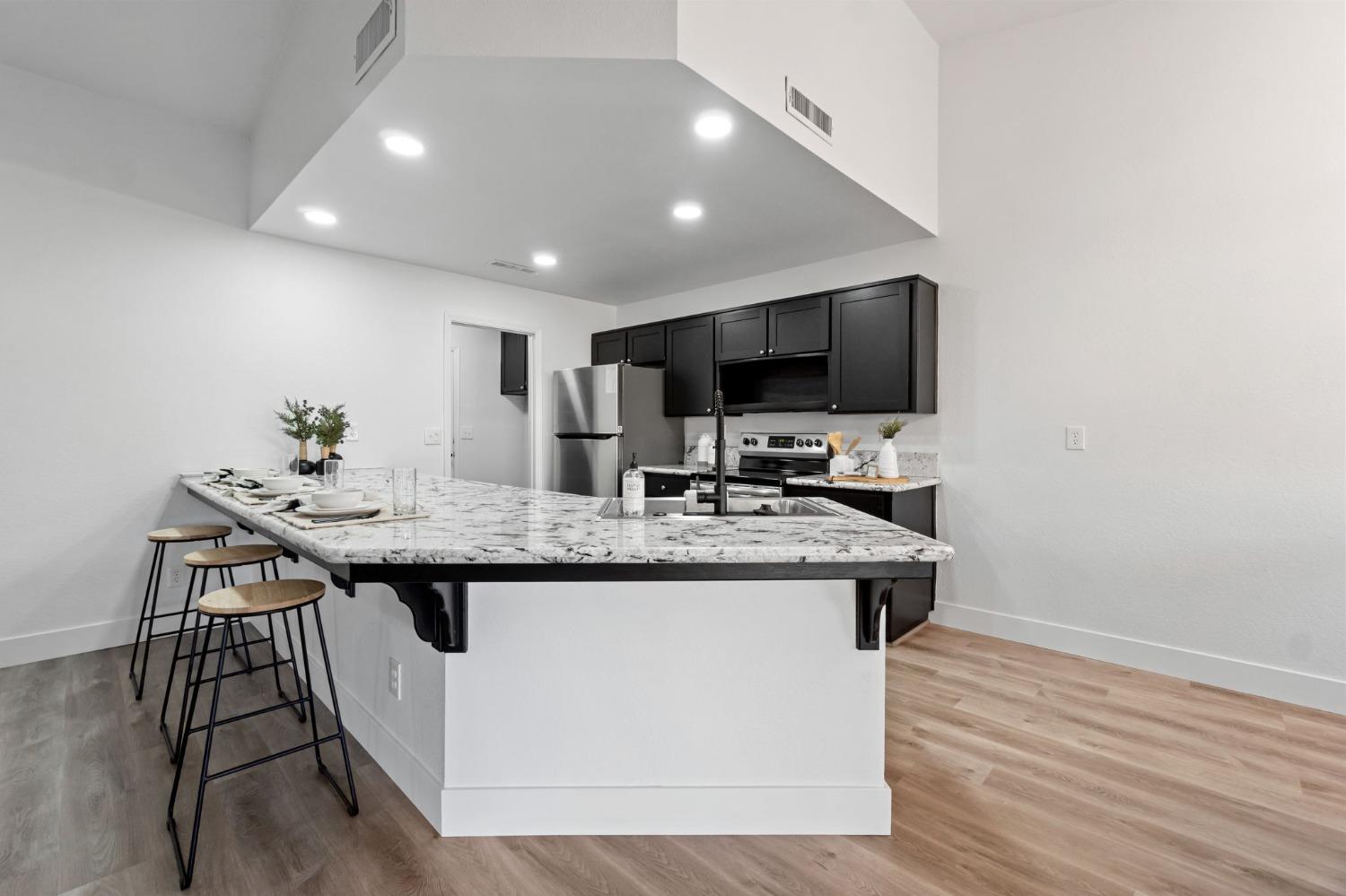 2481 Gibson Avenue Clovis, CA 93611 - Photo 9 of 24 a kitchen with a sink and cabinets