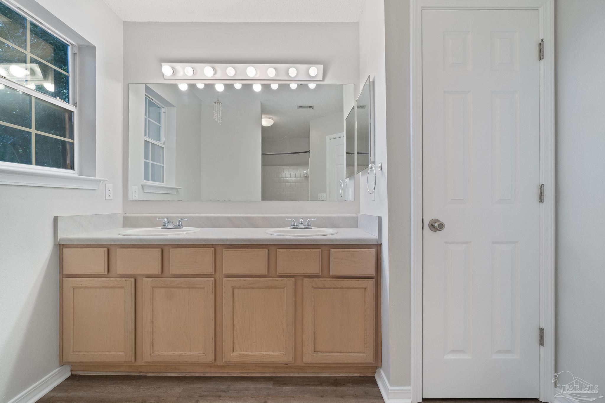 6216 Billoree Road Milton, FL 32571 - Photo 17 of 50 a bathroom with a sink vanity and mirror