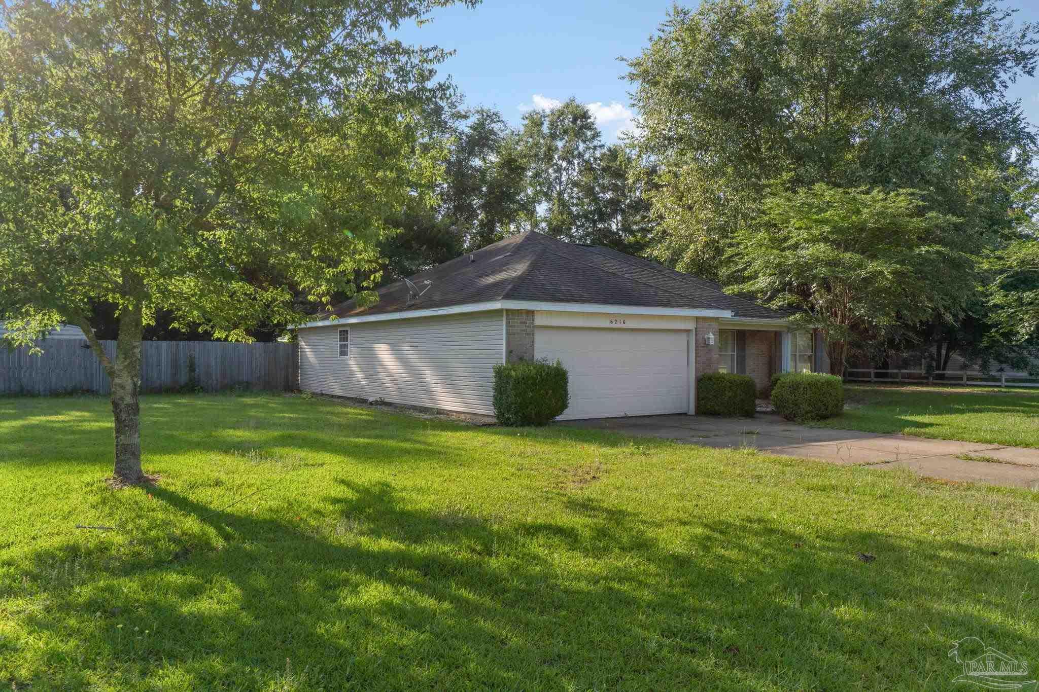 6216 Billoree Road Milton, FL 32571 - Photo 2 of 50 a view of a house with a yard and a large tree
