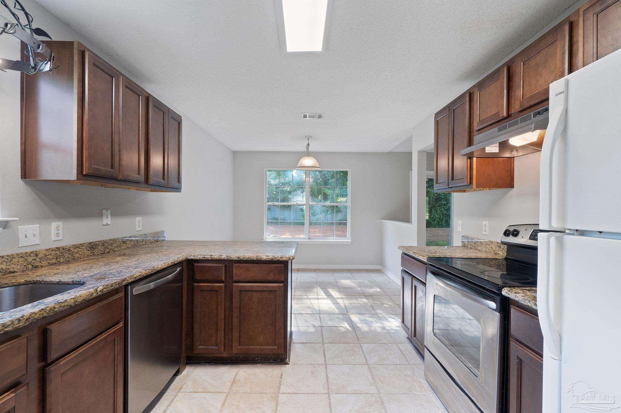 6216 Billoree Road Milton, FL 32571 - Photo 30 of 50 a kitchen with a sink stove and cabinets