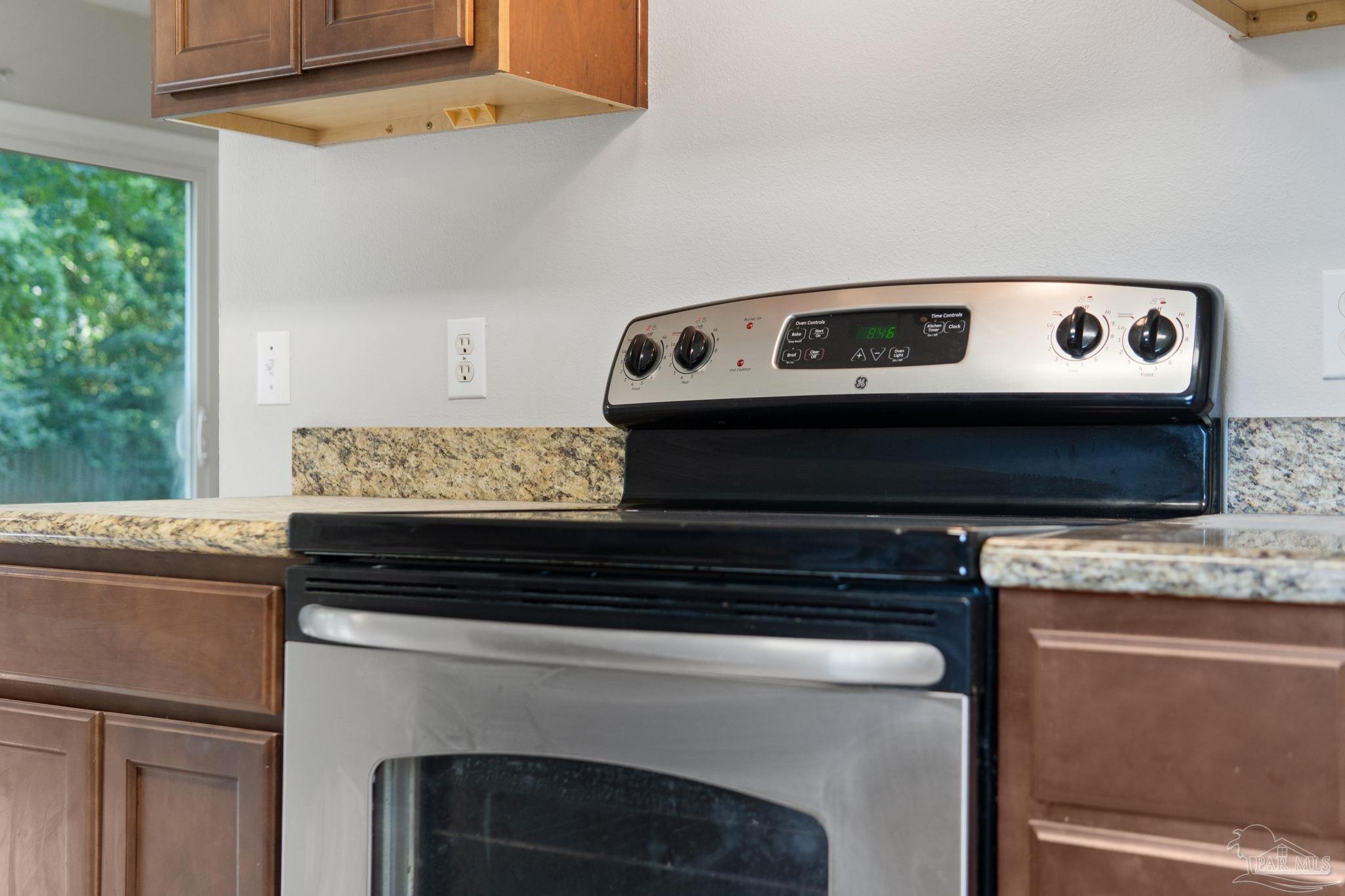 6216 Billoree Road Milton, FL 32571 - Photo 31 of 50 a kitchen with a stove and a microwave