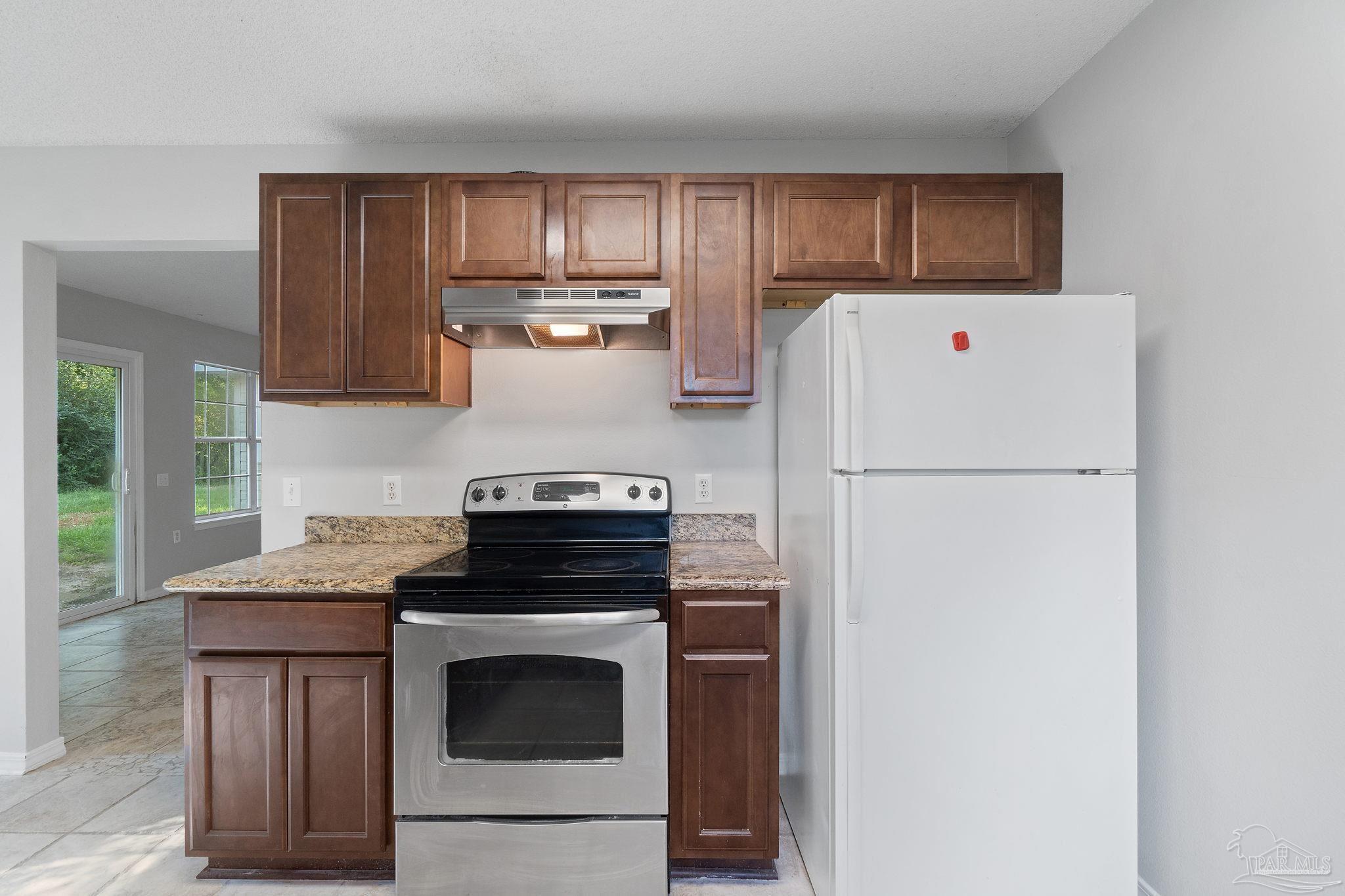 6216 Billoree Road Milton, FL 32571 - Photo 32 of 50 a kitchen with a stove a refrigerator and a sink