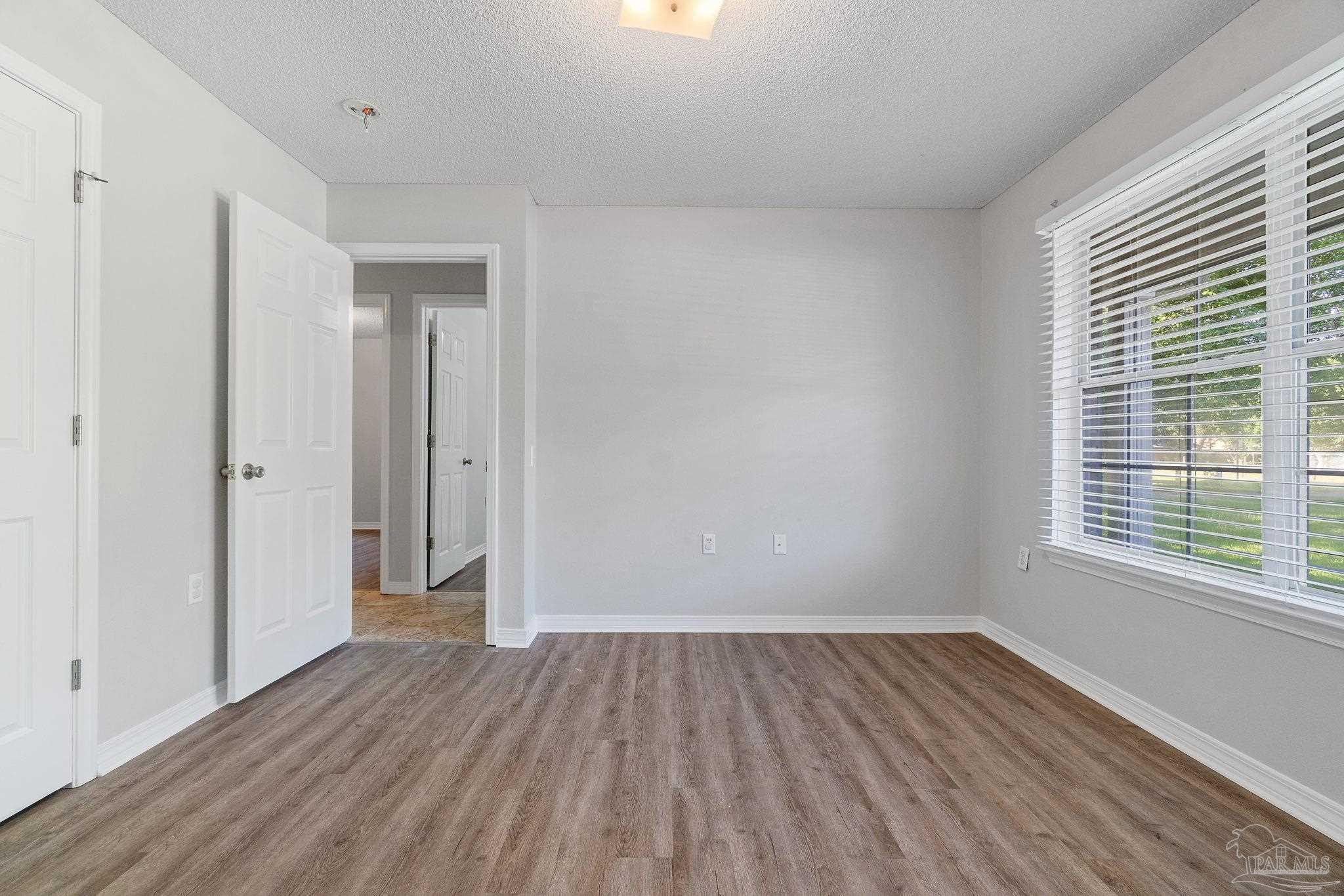 6216 Billoree Road Milton, FL 32571 - Photo 6 of 50 a view of a room with wooden floor and window